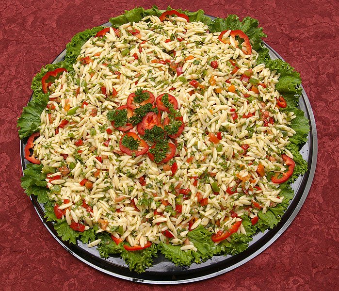 Orzo salad party tray — pasta with parsley, onions, peppers, tomatoes, olive oil